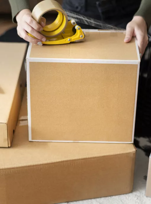 person taping box